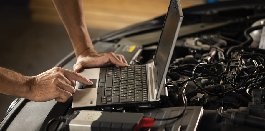 specialist inspecting the vehicle in order to find broken components and errors in data logs